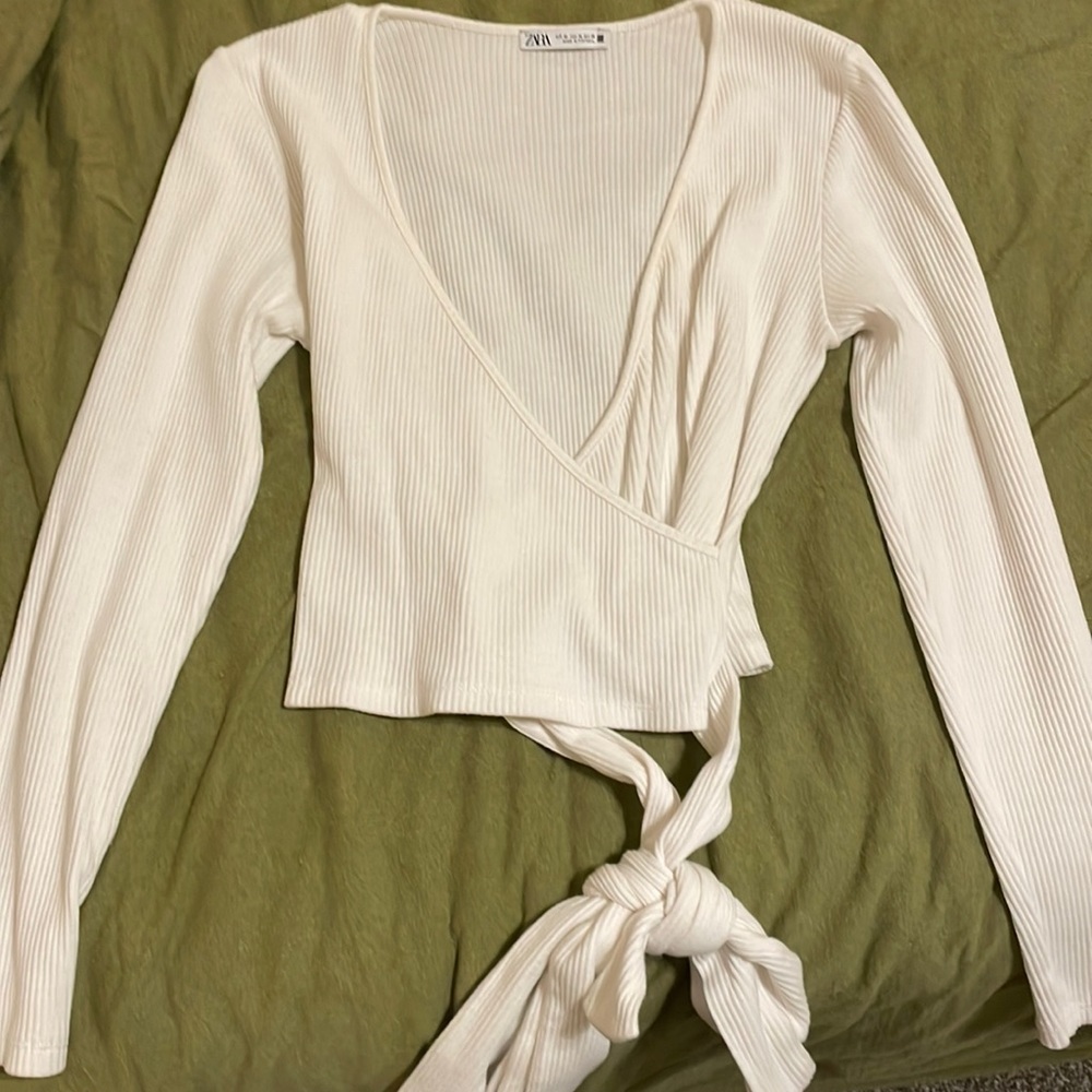 White cross shirt with tie at bottom.